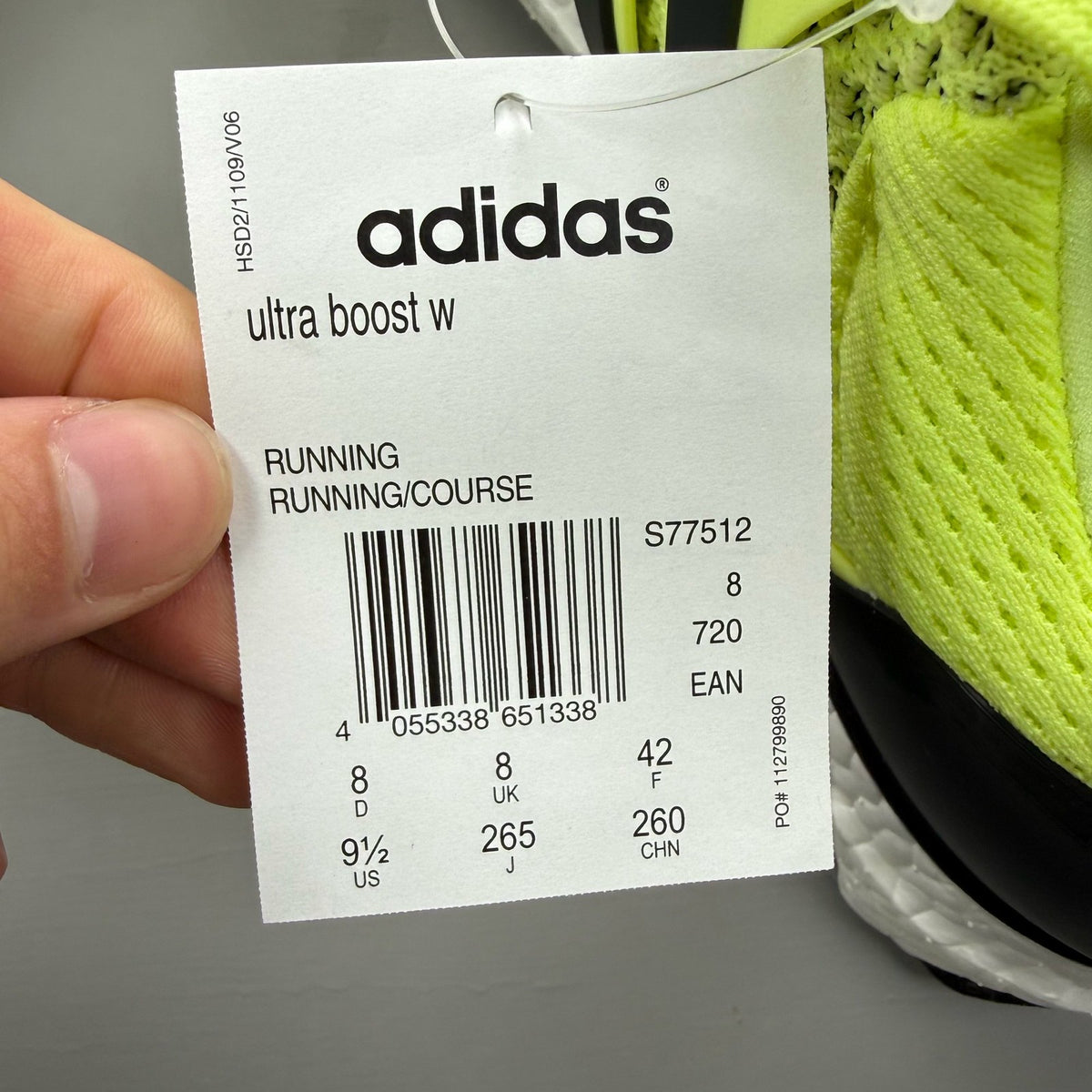 Adidas UltraBoost 1.0 yellow trainers with black and white accents, mesh upper.
