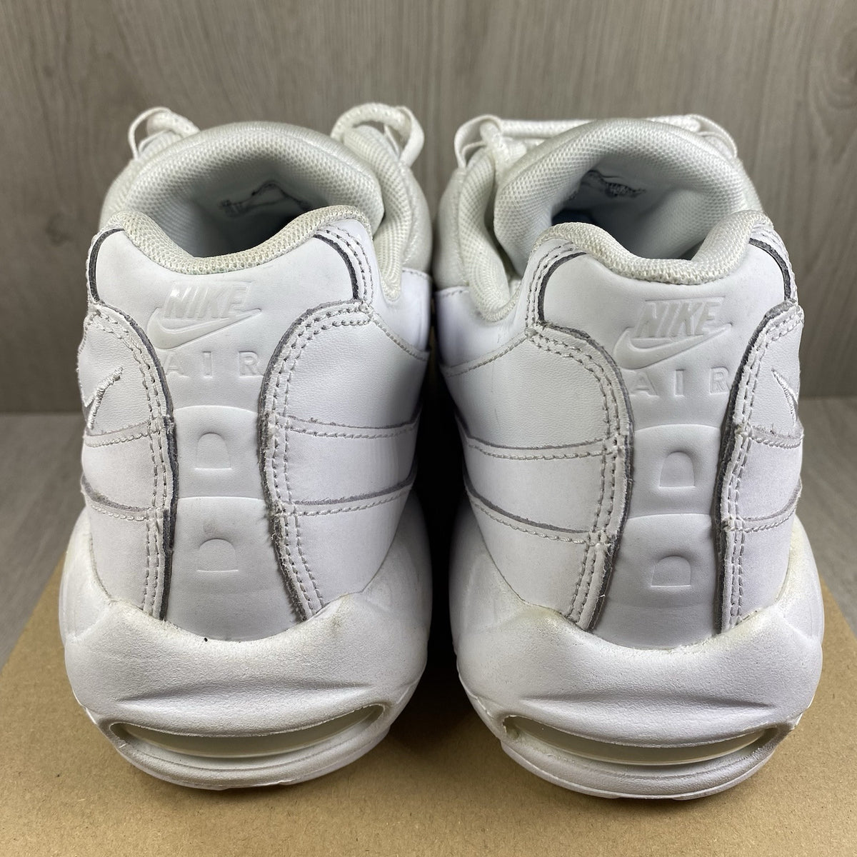 Nike Air Max 95 trainers white mesh upper with signature swoosh logo and layered design.