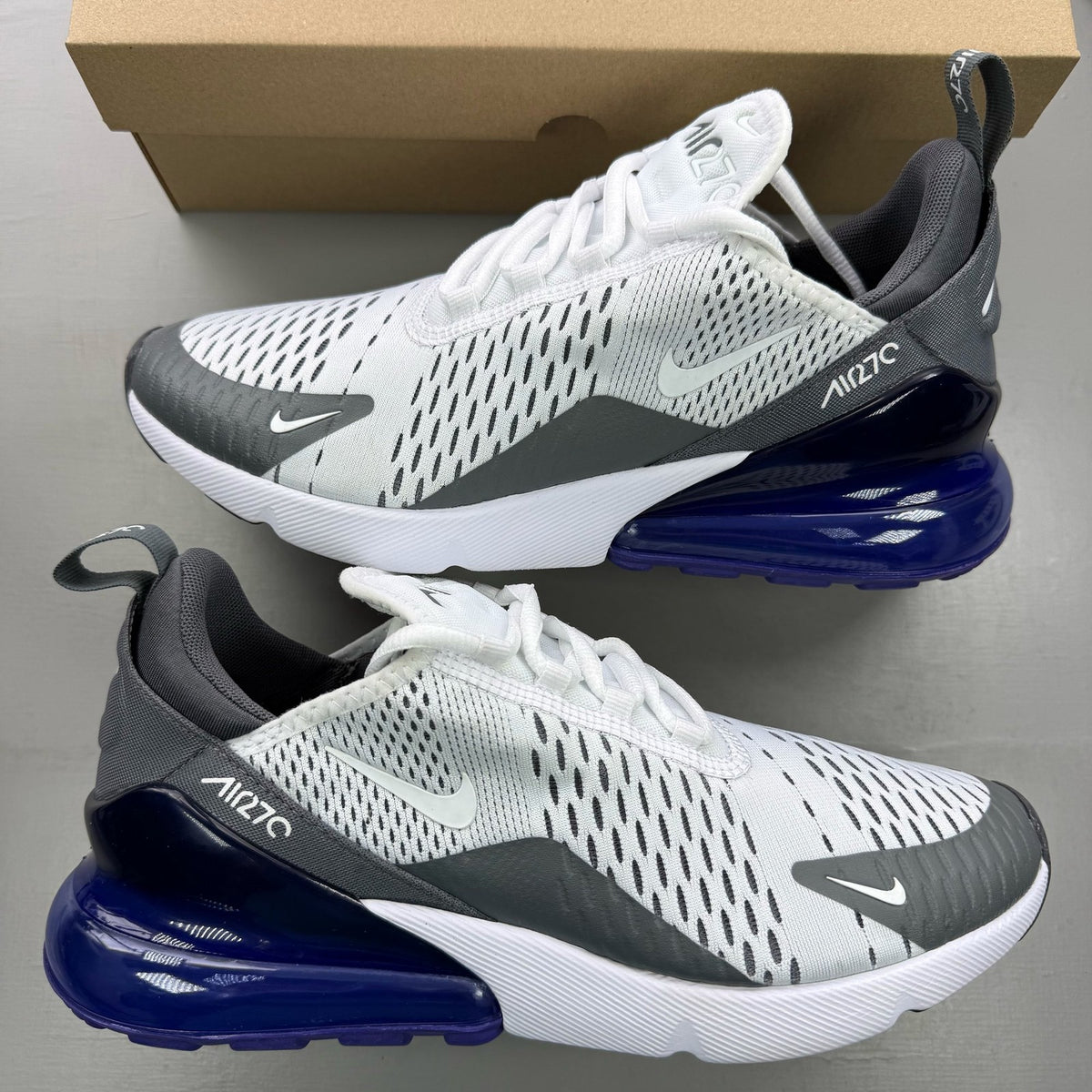 Nike Air Max 270 white trainers with Persian Violet accents and logo detail.