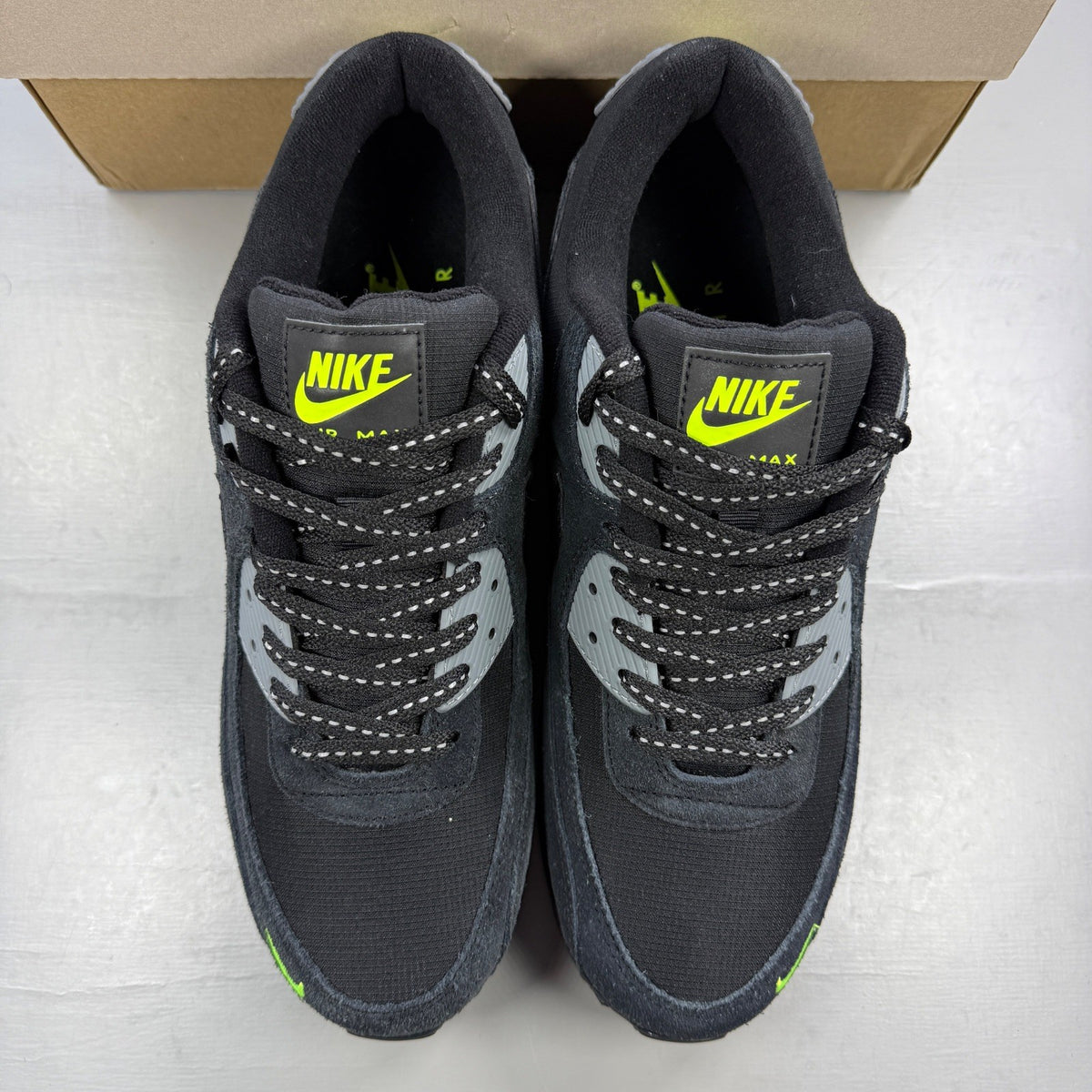 Nike running shoes black with volt accents and mini swoosh logo.