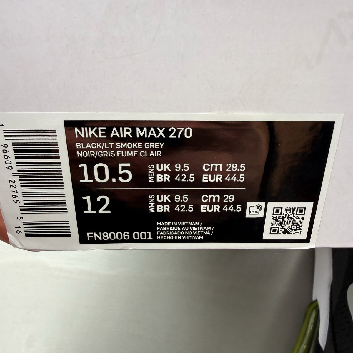 Nike black trainers with Opti Yellow accents and Air Max cushioning.