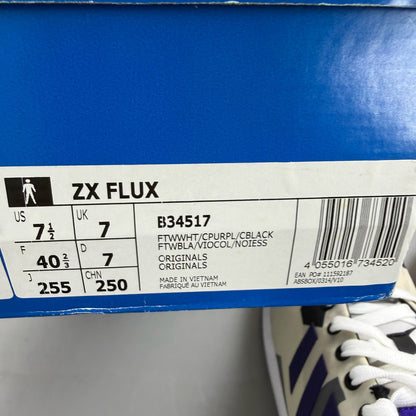 Adidas ZX Flux white trainers with purple and black accents, featuring iconic three-stripe logo.