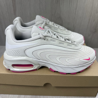 Nike Air Max trainers beige with pink accents and logo detail on the side.