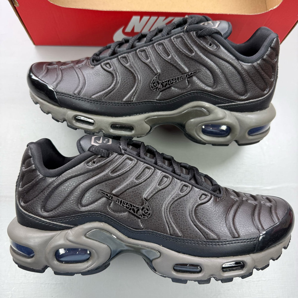 Nike Air Max Plus TN Premium black trainers with signature logo and sleek design.