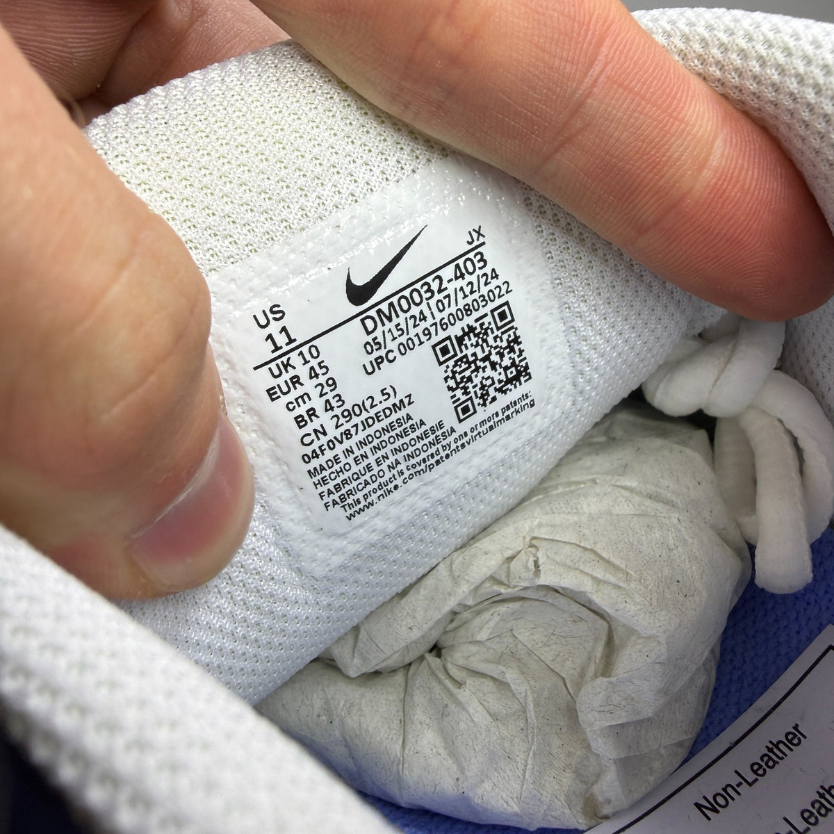 Nike running shoes blue with signature logo and textured mesh upper.