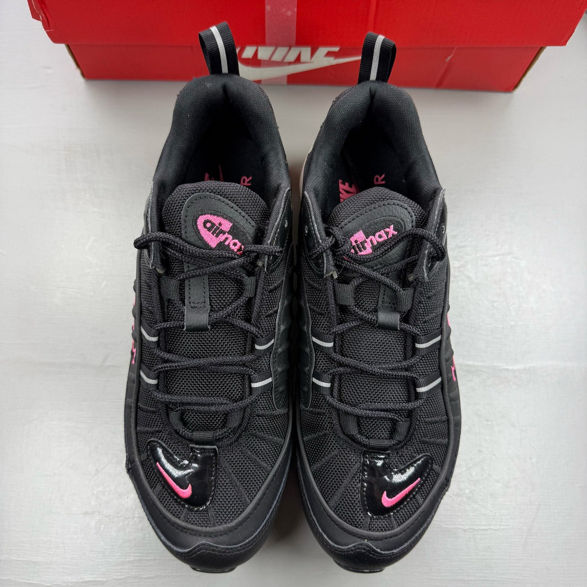 Nike Air Max 98 black trainers with crimson and pink accents, mesh and leather material.