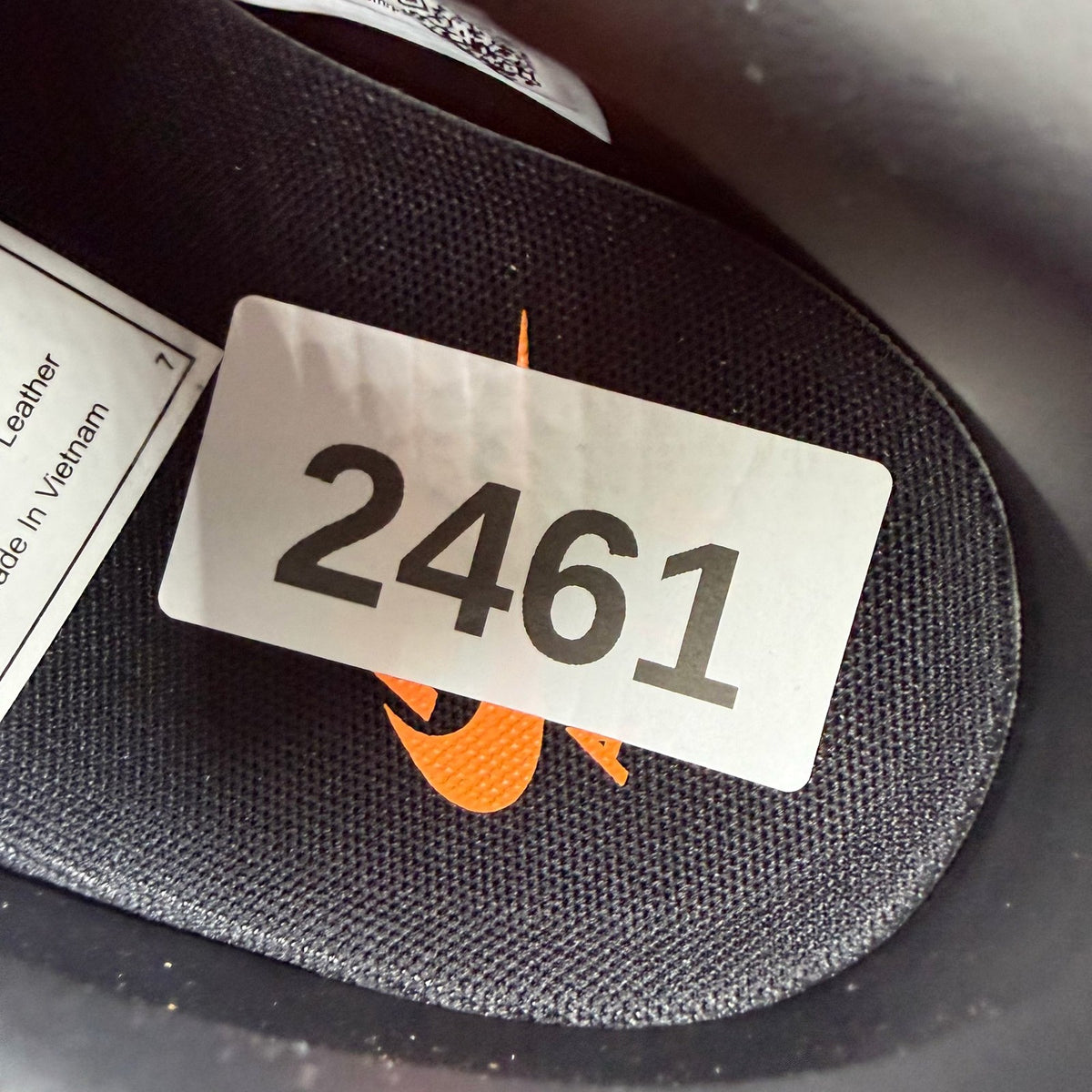 Nike black trainers with bright citrus accents and Hypervenom design details.
