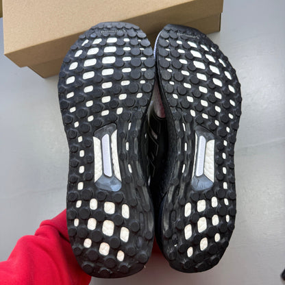 Adidas running shoes white with black accents and Boost cushioning technology.