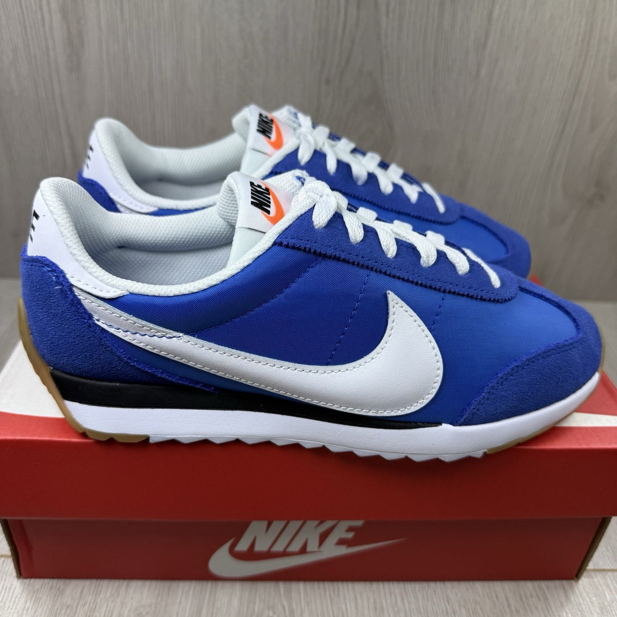 Nike blue trainers with white swoosh logo and mesh upper details.