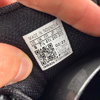 Adidas black grey LA Trainer sneakers with woven upper and iconic three-stripe logo.