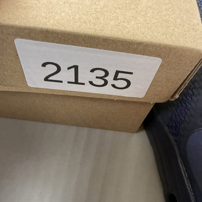 Nike Air Max Zero blue trainers with black accents and logo detailing.