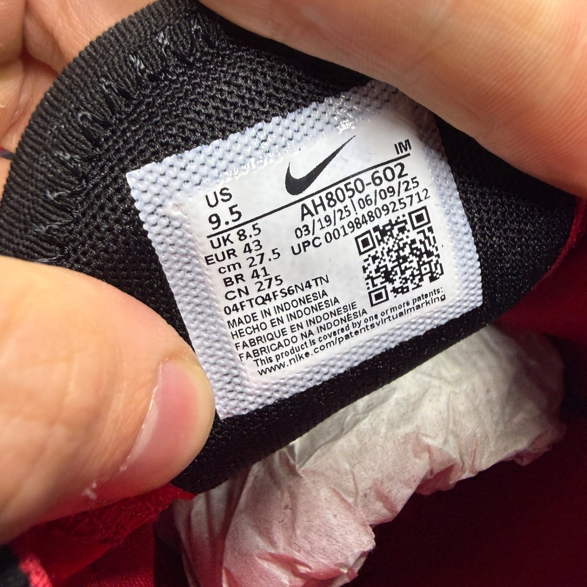 Nike trainers red with black and white accents, featuring Air Max cushioning and logo.