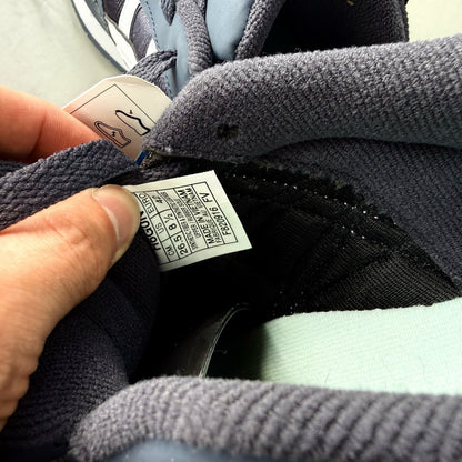 ASICS blue trainers with white accents and logo detail on the side.