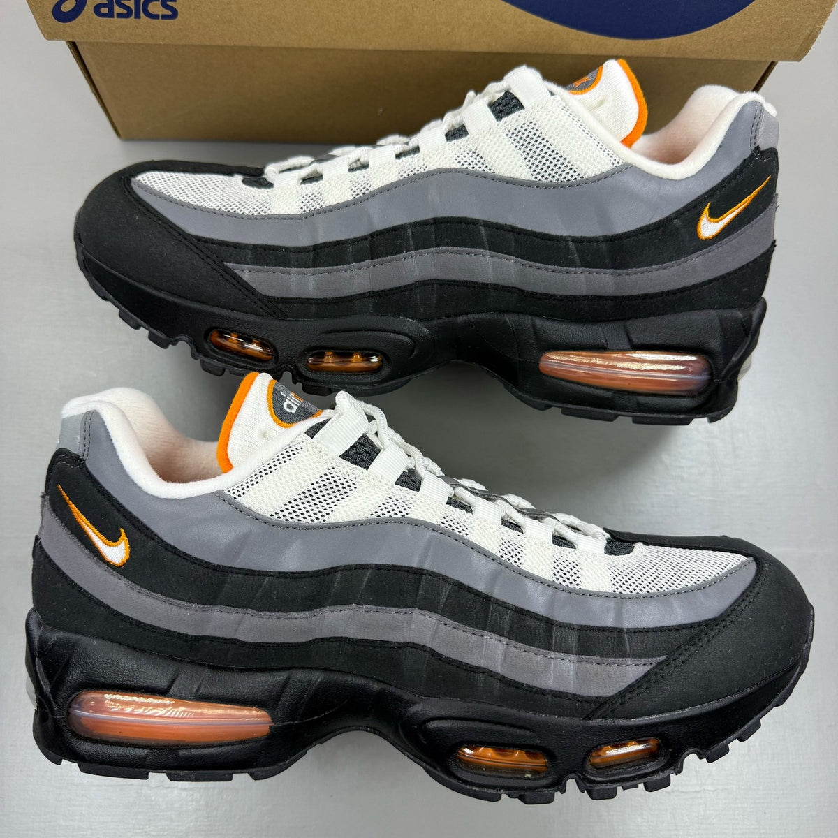 Nike Air Max 95 grey trainers with big bubble design and signature swoosh logo.