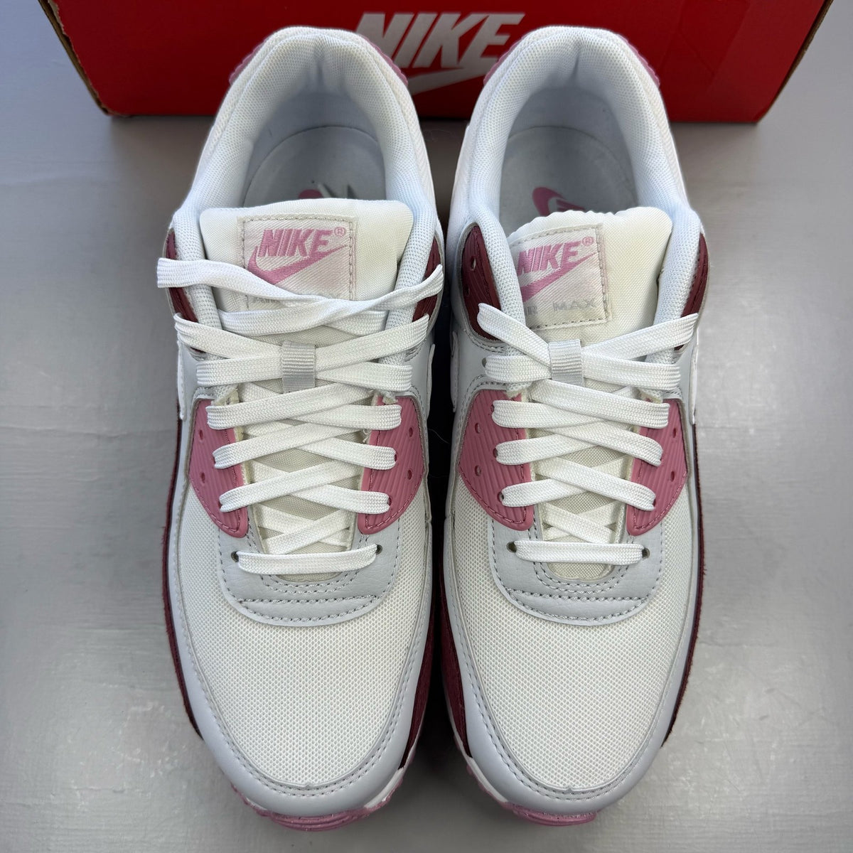 Nike Air Max 90 SE trainers multi-colour with burgundy and pink accents, logo details.