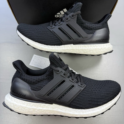 Adidas black Ultra Boost trainers with white accents and signature three-stripe logo.