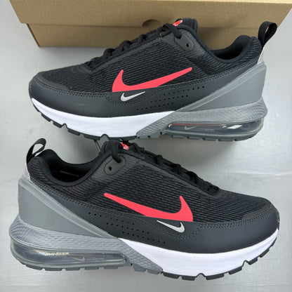 Nike black Air Max Pulse trainers with bright crimson accents and logo detail.