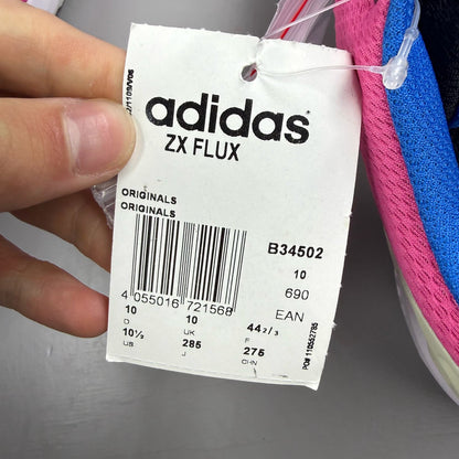 Adidas ZX Flux trainers in shock pink with black and blue accents, mesh upper.