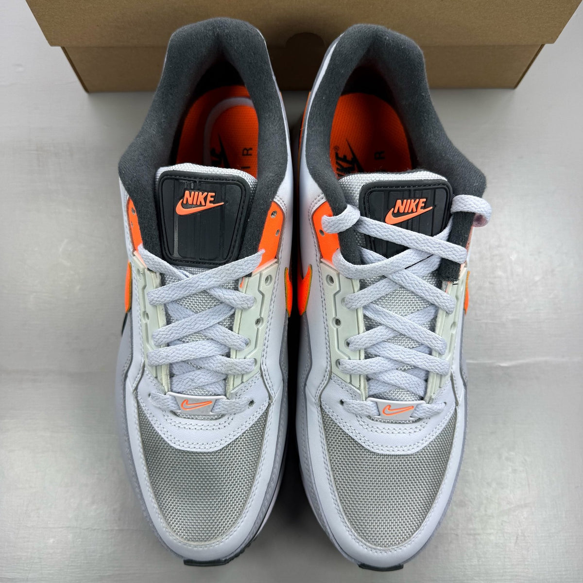 Nike Air Max LTD 3 grey trainers with total orange accents and logo detail.