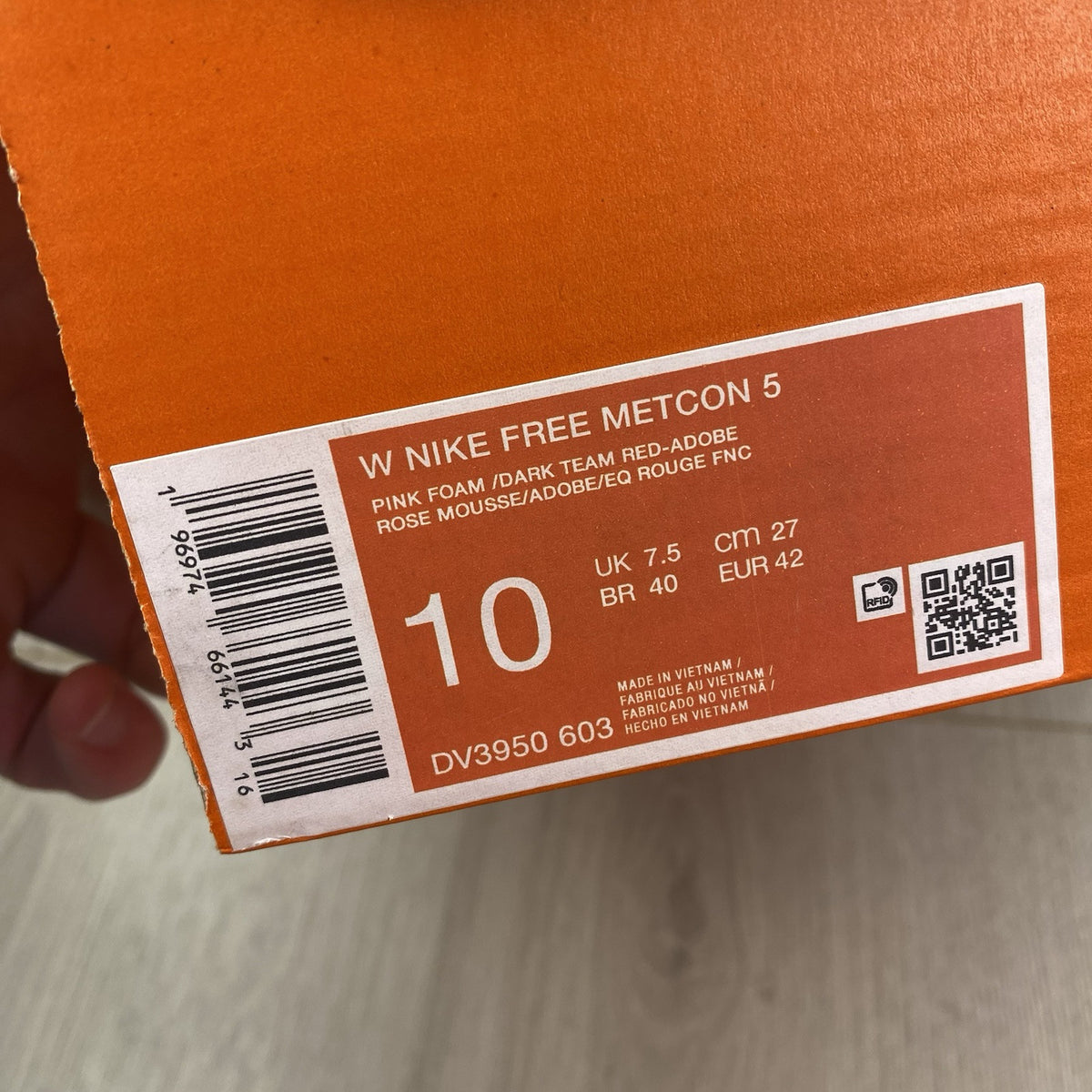 Nike Free Metcon 5 pink foam trainers with white accents and logo detailing.