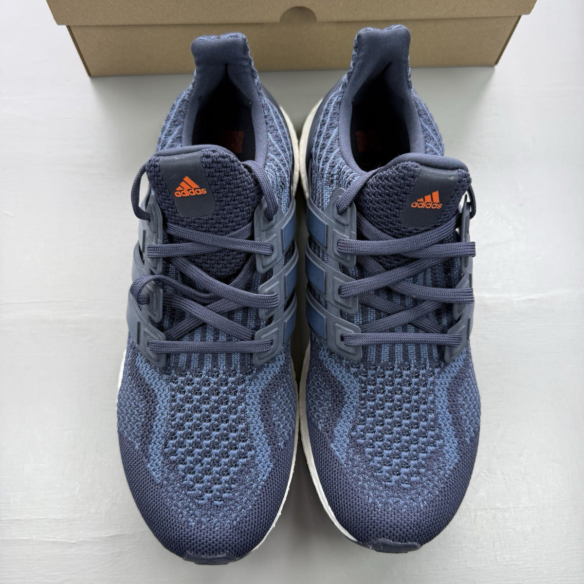 Adidas Ultra Boost 5.0 DNA trainers in navy blue with white accents and logo.
