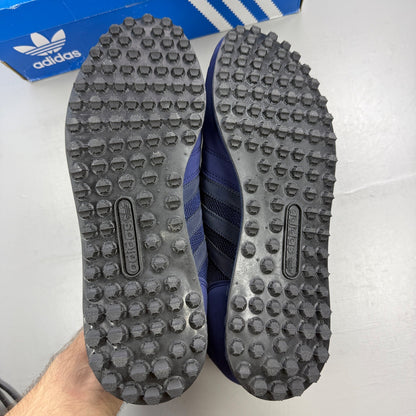 Adidas blue trainers with black accents and signature three-stripe logo.