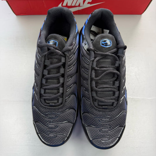 Nike Air Max Plus TN black trainers with blue accents and signature swoosh logo.