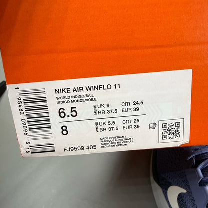 Nike blue trainers with mesh upper and swoosh logo, size UK 6.