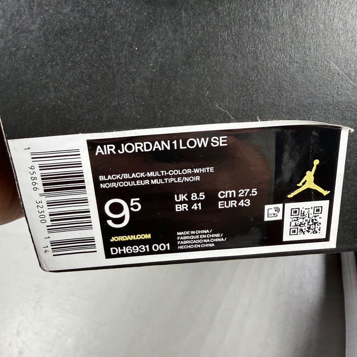 Jordan black athletic shoes with white accents and diamond pattern details.
