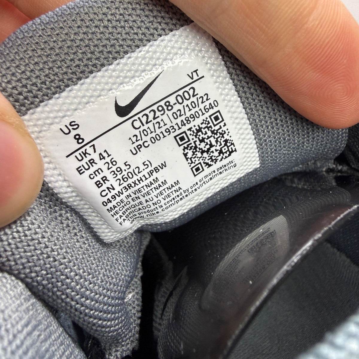 Nike running shoes grey with black accents and signature logo on the side.
