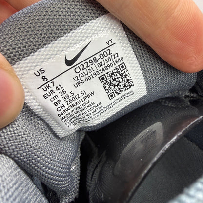 Nike running shoes grey with black accents and signature logo on the side.