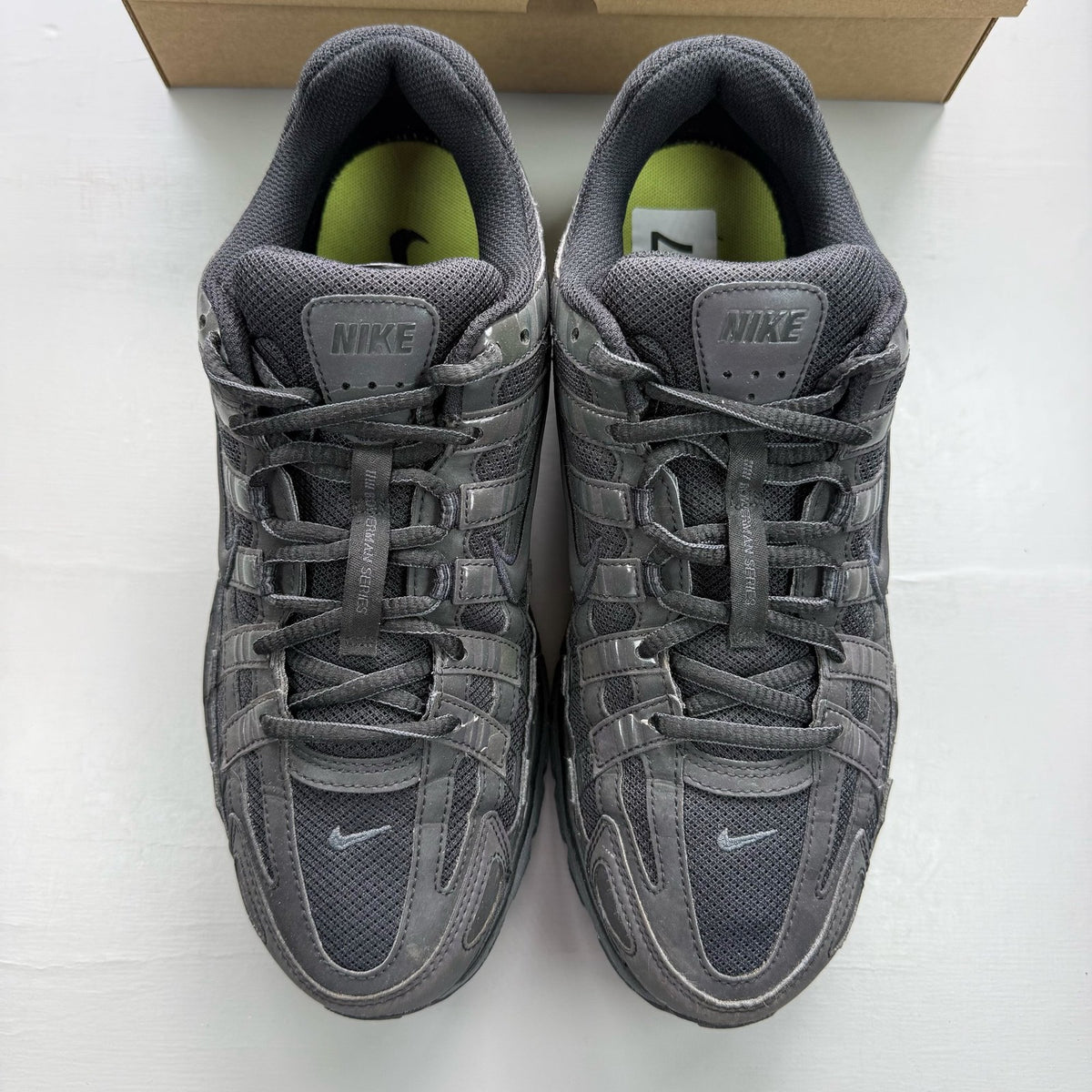 Nike black trainers with reflective detailing and logo on the side.
