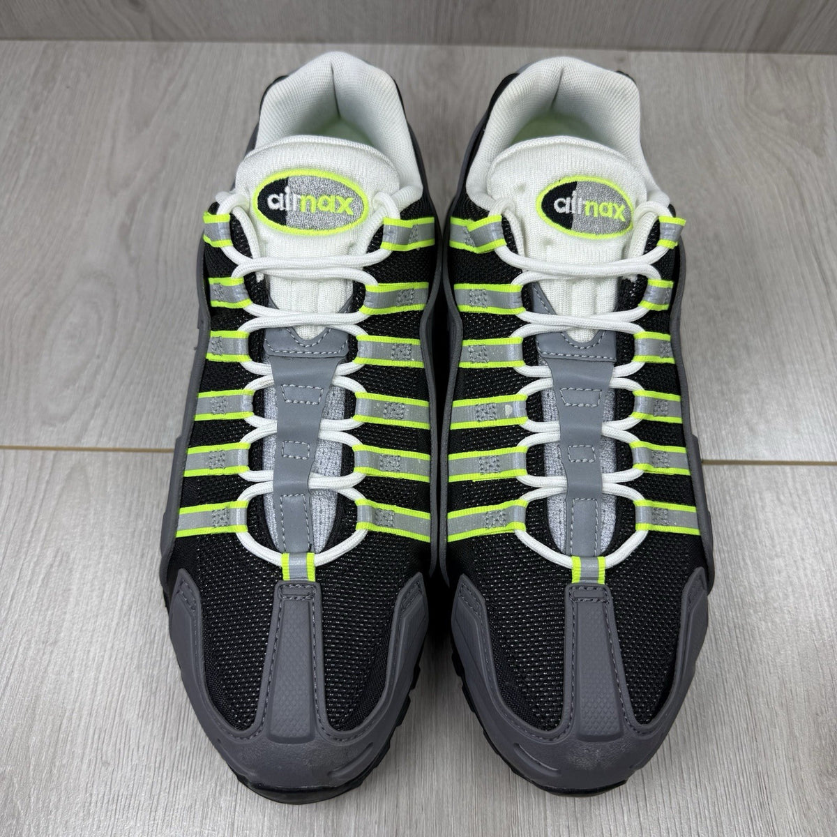 Nike Air Max 95 NDSTRKT black trainers with neon accents and textured mesh upper.