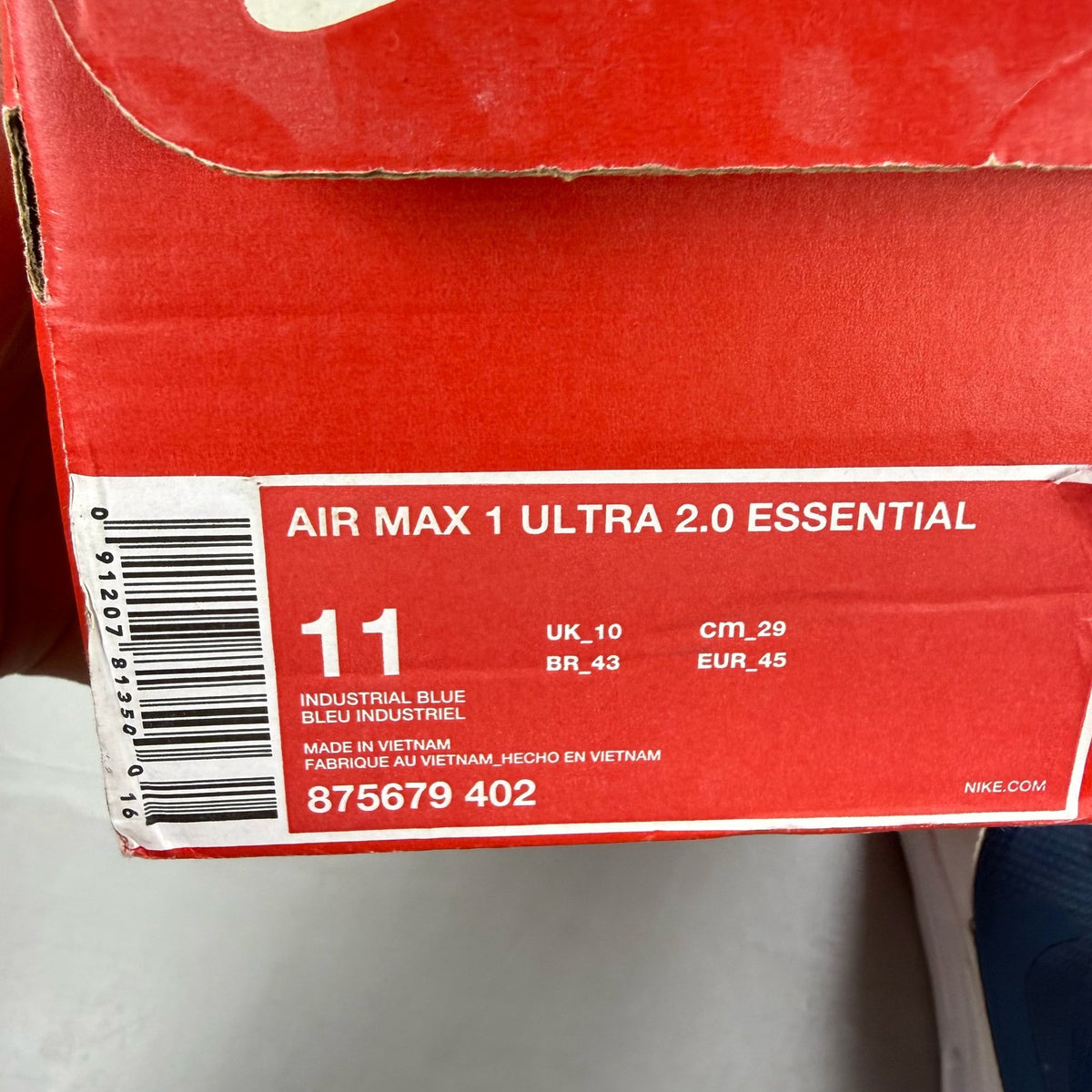 Nike Air Max 1 blue trainers with essential design and logo detail.