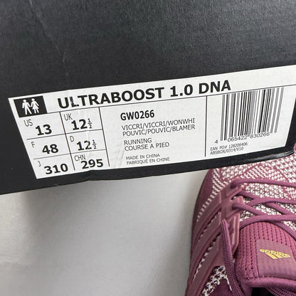 Adidas UltraBoost 1.0 DNA red trainers with signature three stripes and knit upper.