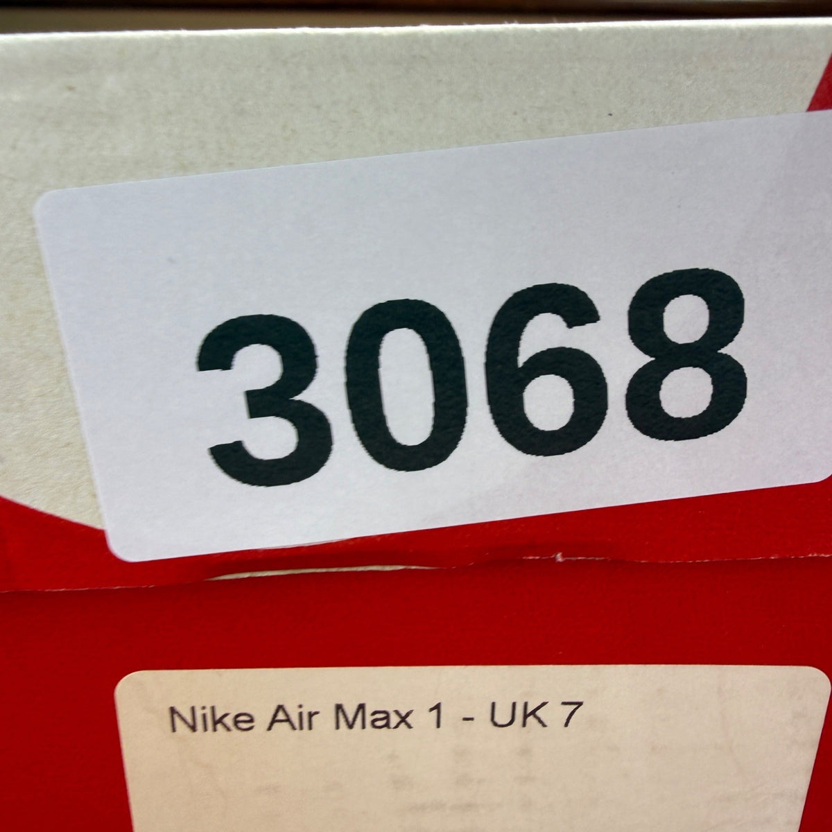 Nike Air Max 1 white trainers with rubberized details and classic logo design.