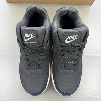 Nike Air Max 90 grey trainers with blue accents and logo detailing.