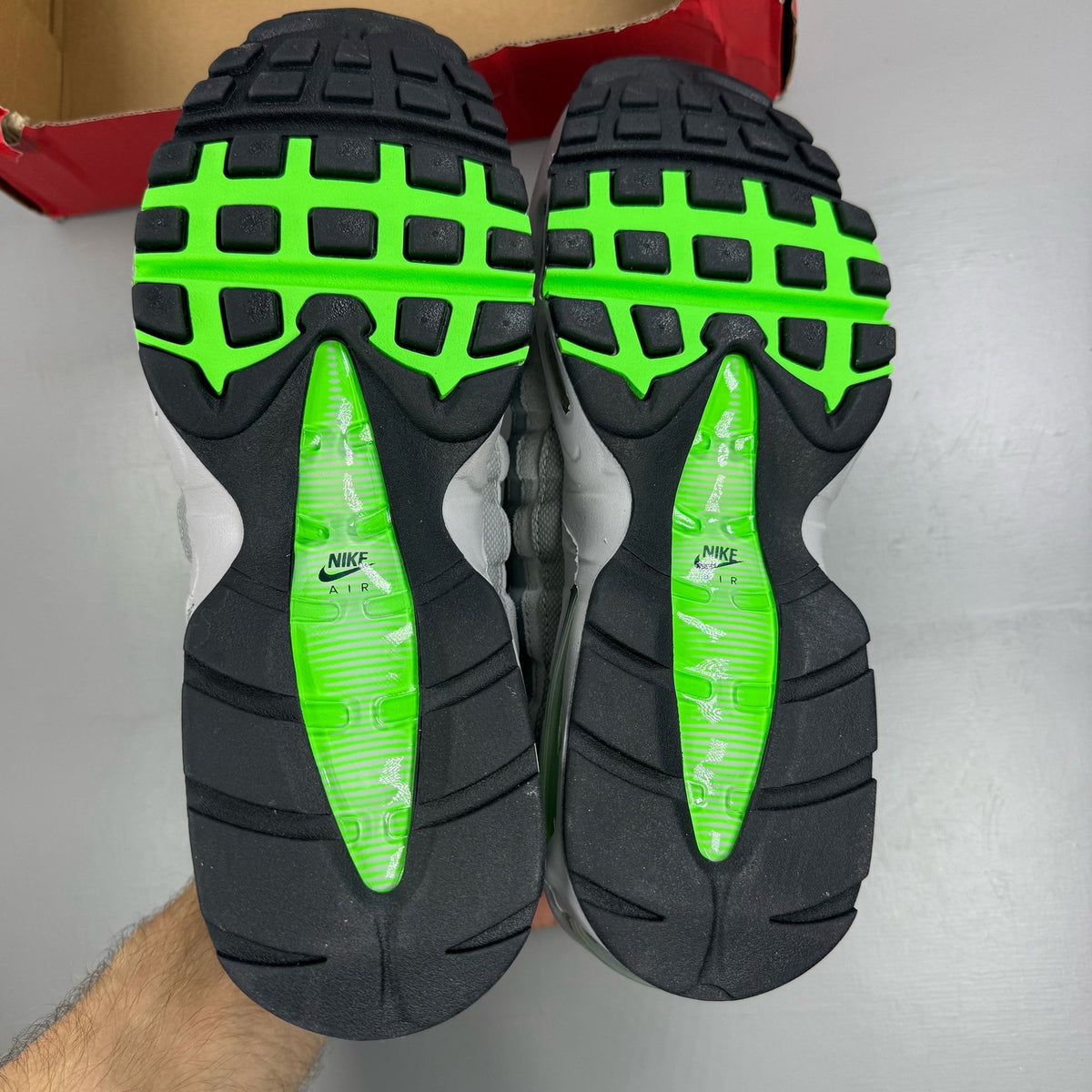 Nike Air Max 95 black trainers with green strike accents and textured upper.