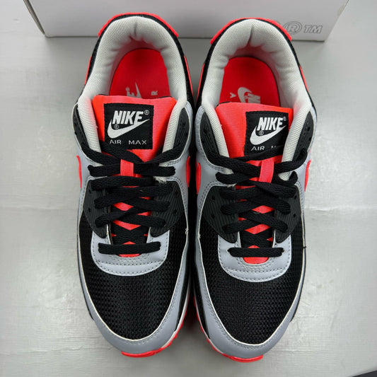Nike Air Max 90 black trainers with radiant red and wolf grey accents, logo detail.