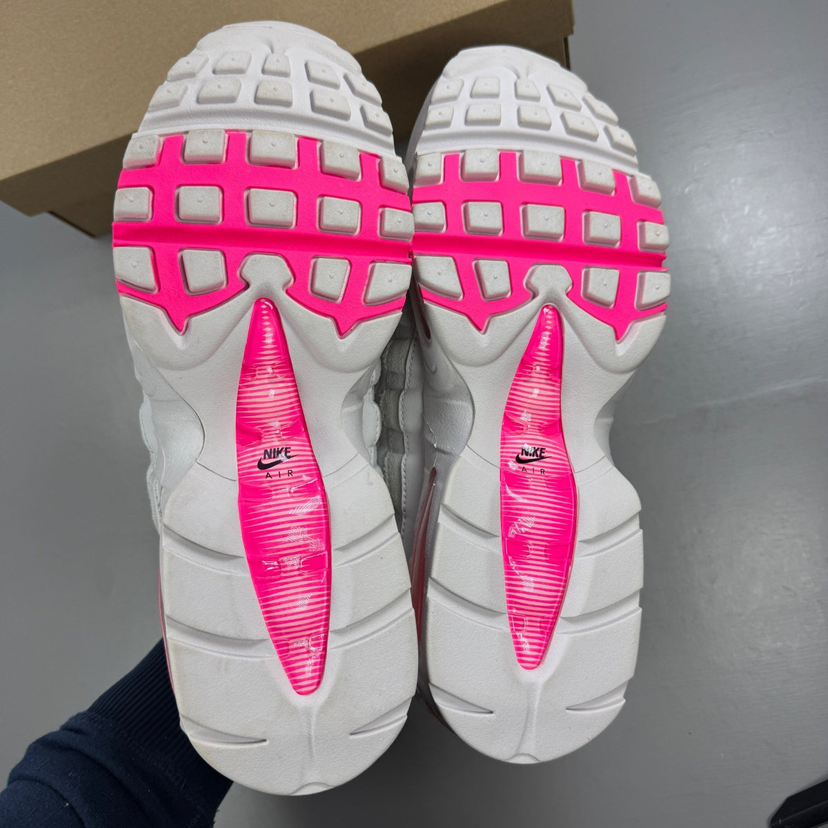 Nike running shoes white with pink accents and visible logo details.