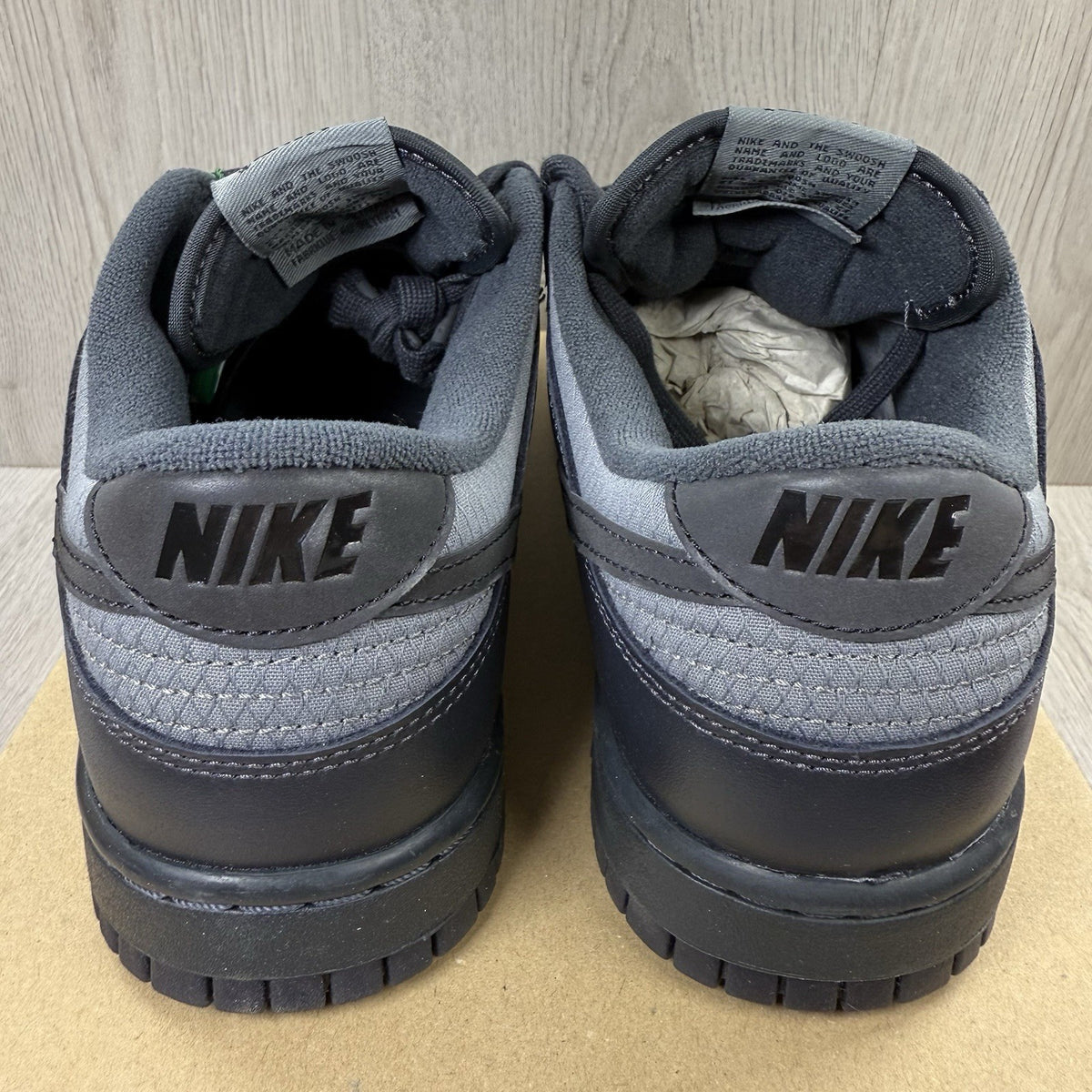 Nike Dunk Low Retro Off Noir grey trainers with black accents and signature swoosh logo.