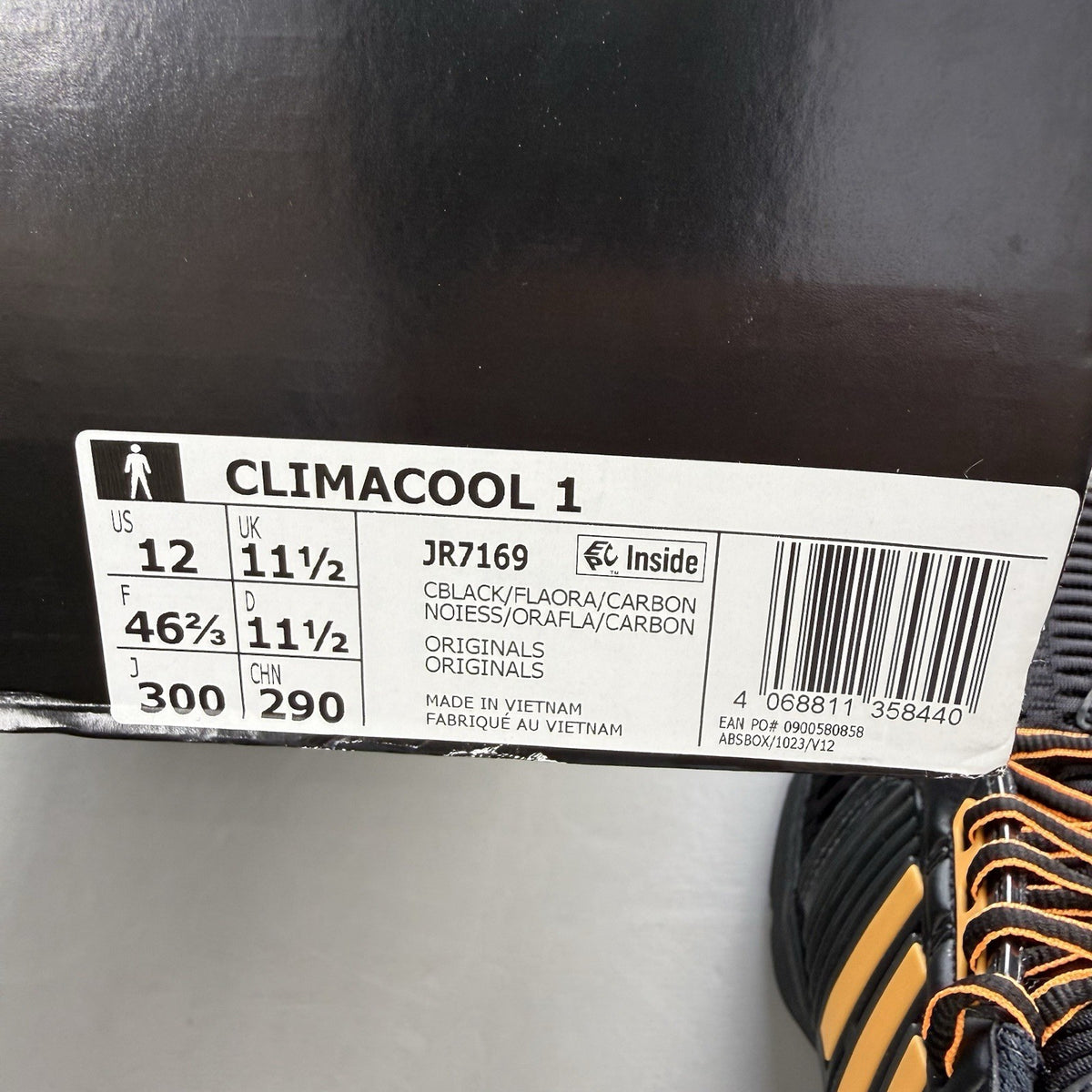 Adidas black trainers with flash orange accents and Climacool ventilation design.