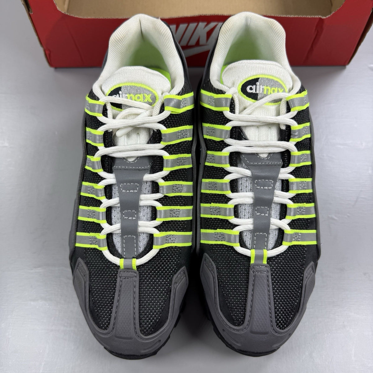 Nike NDSTRKT Air Max 95 black trainers with neon accents and textured material.