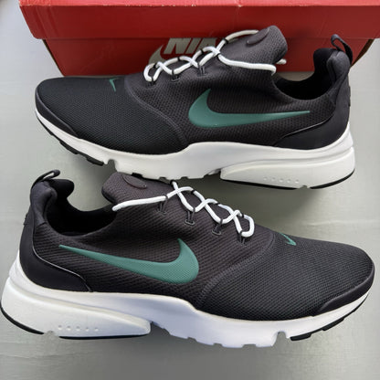 Nike Presto Fly black trainers with grey accents and white sole, featuring logo details.