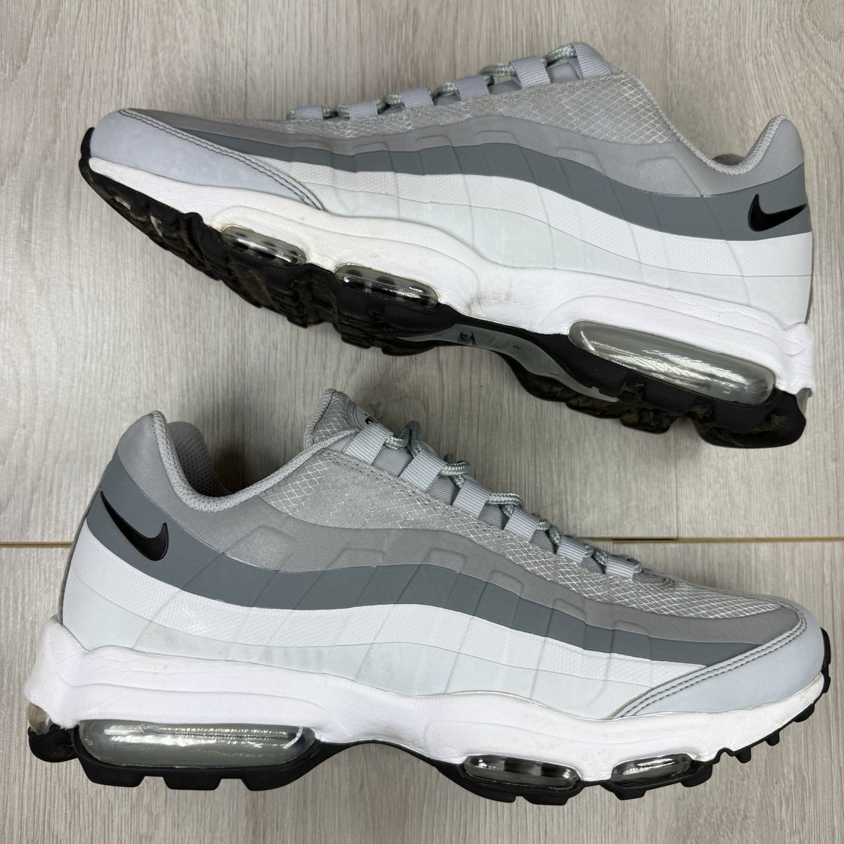 Nike Air Max 95 Ultra grey trainers with white accents and signature logo detailing.