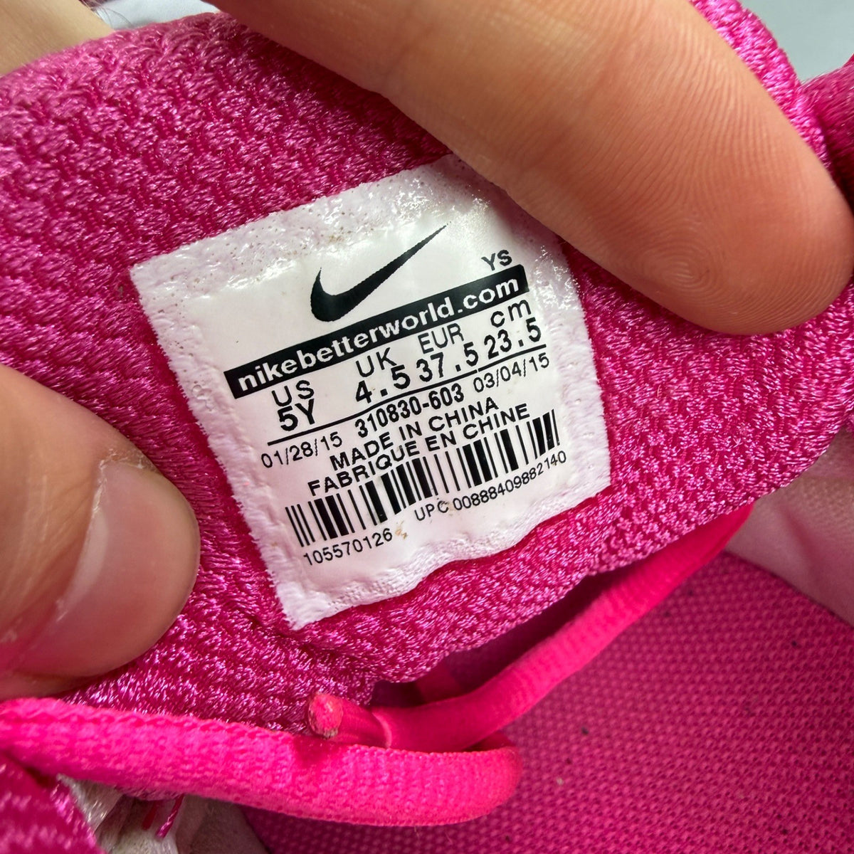 Nike running shoes vivid pink and white with mesh upper and Air Max cushioning.