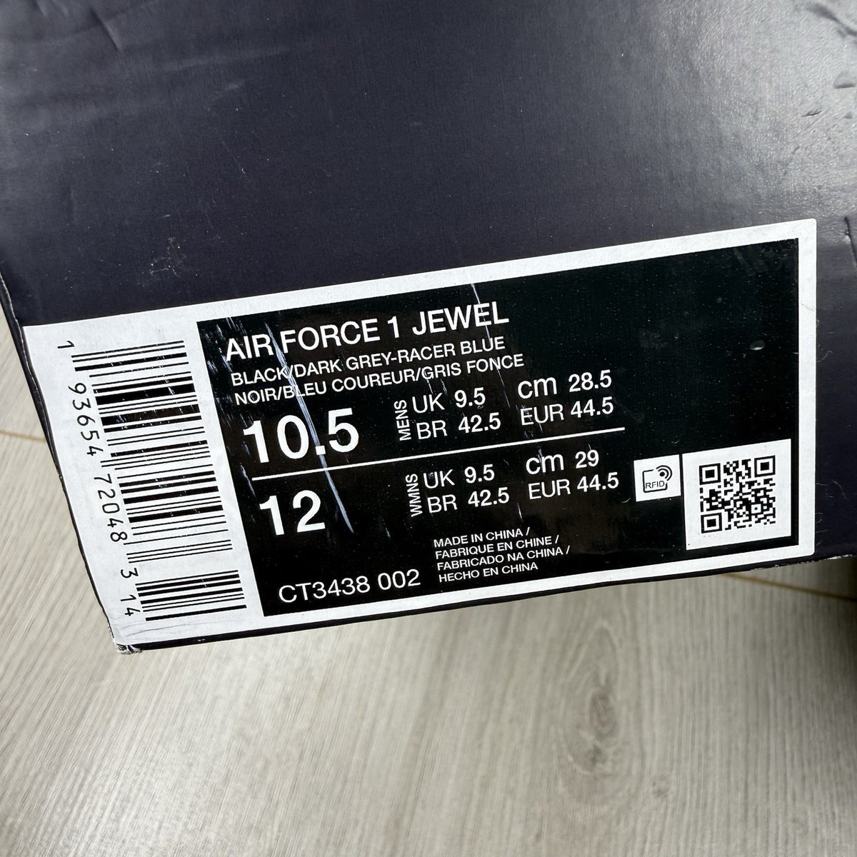 Nike black Air Force 1 Low trainers with jewel swoosh logo and grey accents.