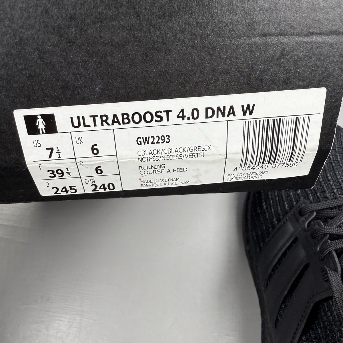Adidas black trainers with grey accents and signature three-stripe logo.