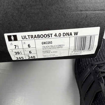 Adidas black trainers with grey accents and signature three-stripe logo.