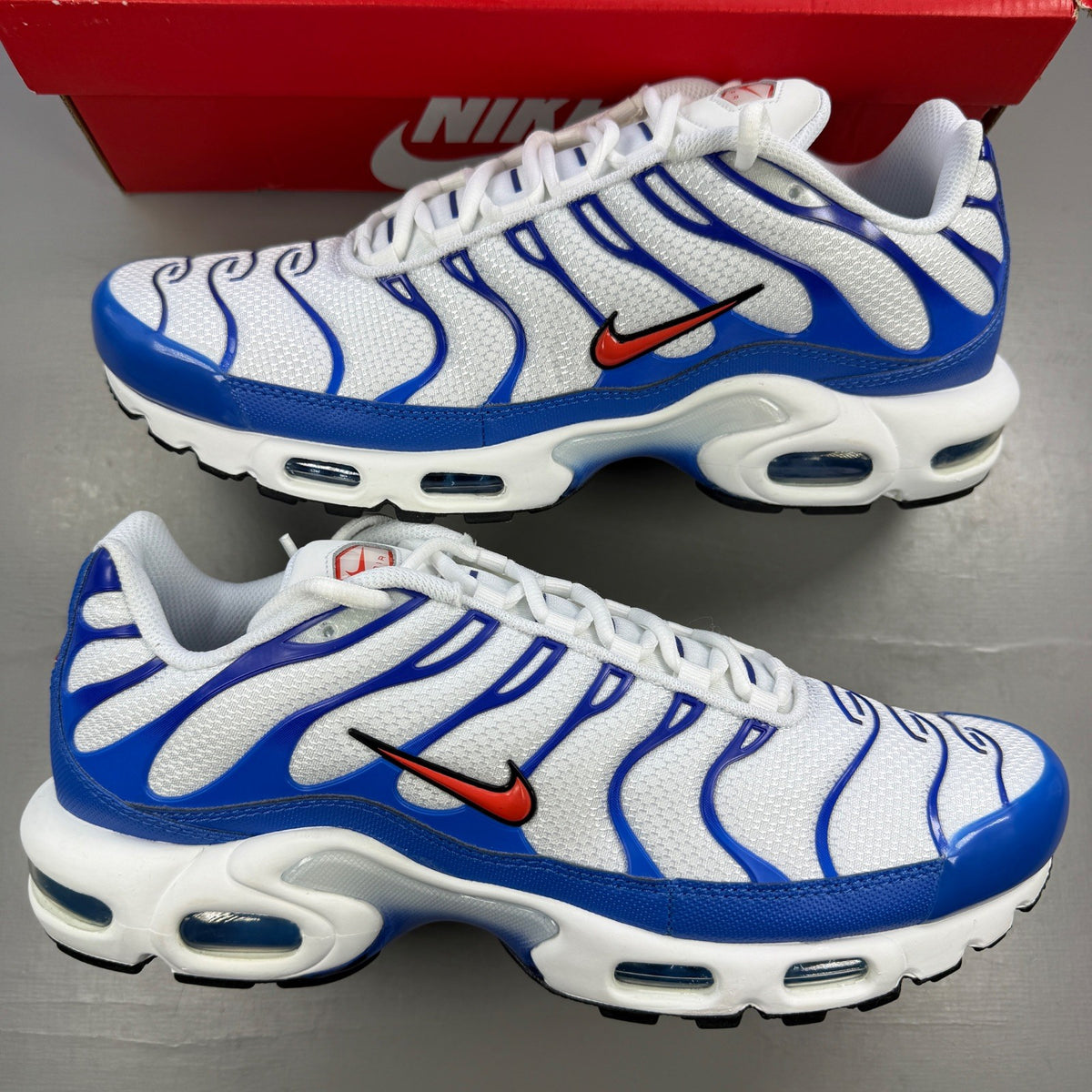 Nike running shoes white with blue accents and signature swoosh logo.